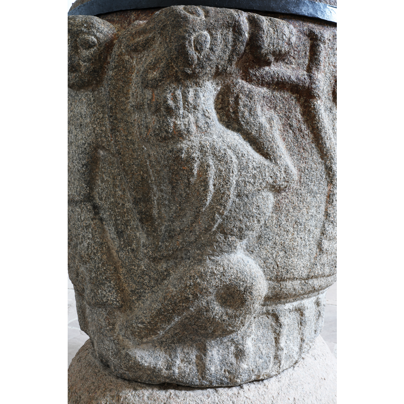 the lion bites the head of the figure who holds his arm to a branch of a Tree of Life (?)