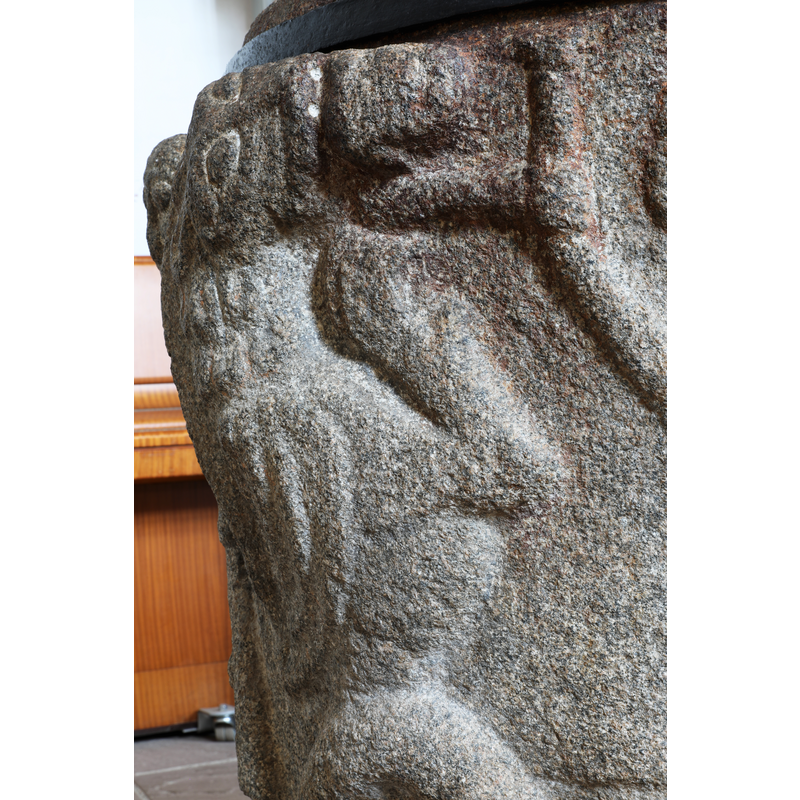 the lion bites the head of the figure who holds his arm to a branch of a Tree of Life (?)