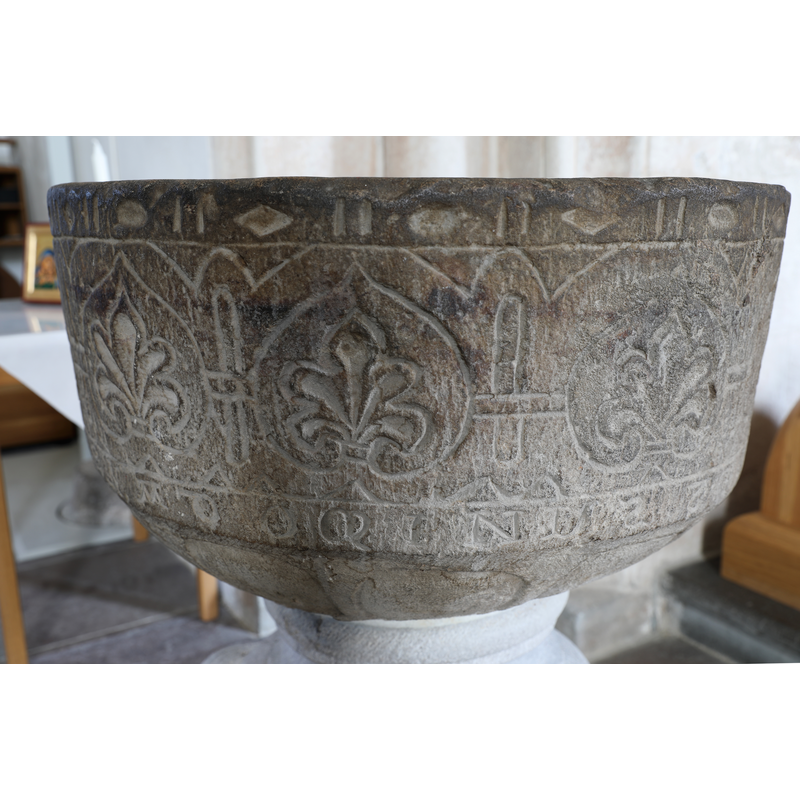 showing the old basin, on a new base, re-installed in the church
