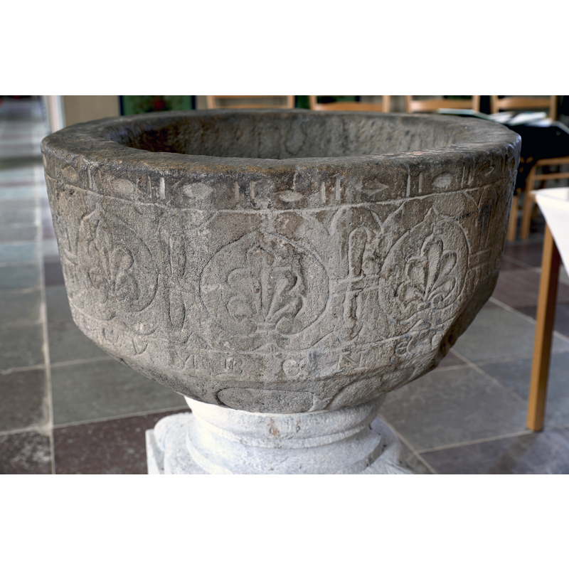 showing the old basin, on a new base, re-installed in the church