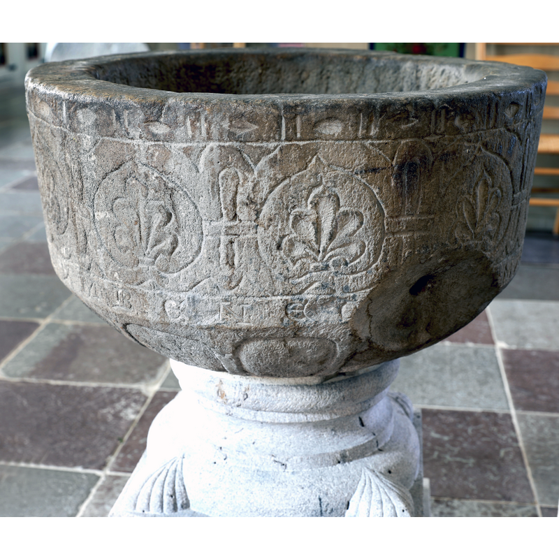 showing the old basin, on a new base, re-installed in the church