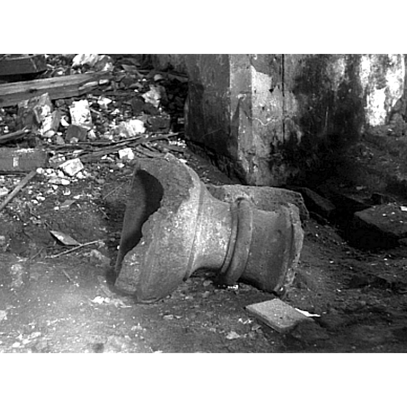 showing the font in the midst of the church interior in 1990, damaged by an explosion