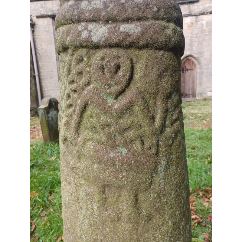 Source caption: "Anglo-Scandinavian cross shaft depicting a Viking warrior, Brailsford churchyard. Possibly a memorial to the person depicted. Early 11th century, scheduled monument. Churchyard of All Saints' Church, Brailsford, Derbyshire, England."