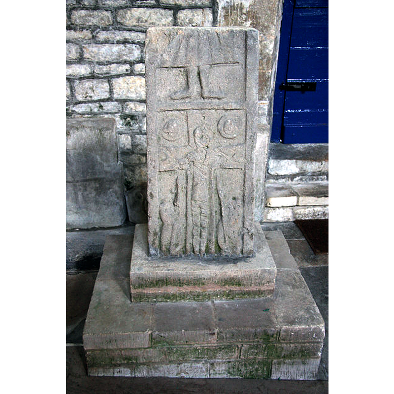 Source caption: "Saxon cross shaft. Fragment of a 10th century cross depicting Christ on the cross with a spear and reed, the feet above would have continued with a respresentation of The Ascension. When complete, the cross has been estimated to have stood 10 feet high. It was discovered during restoration work in the 1880s."