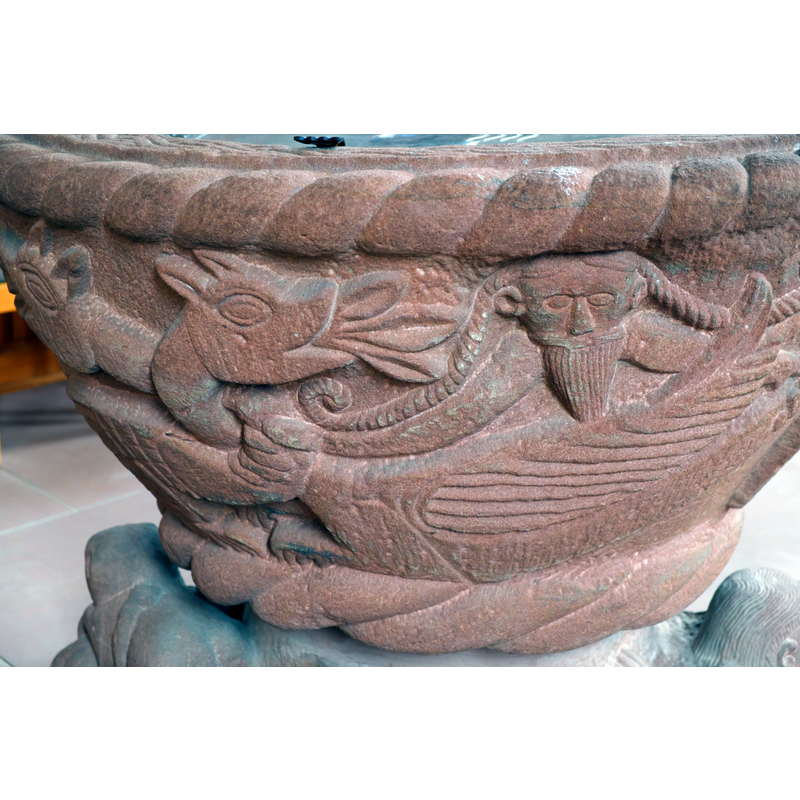 the beasts appear to have their necks twisted around each other; the bodies(?) show a long fish tail and wings