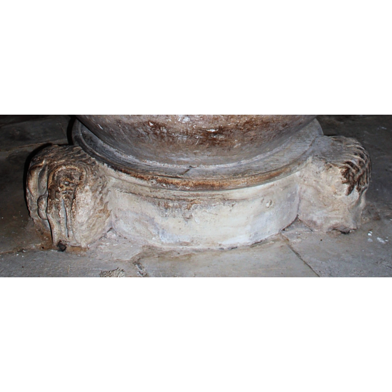 Three large lion heads at the upper base.