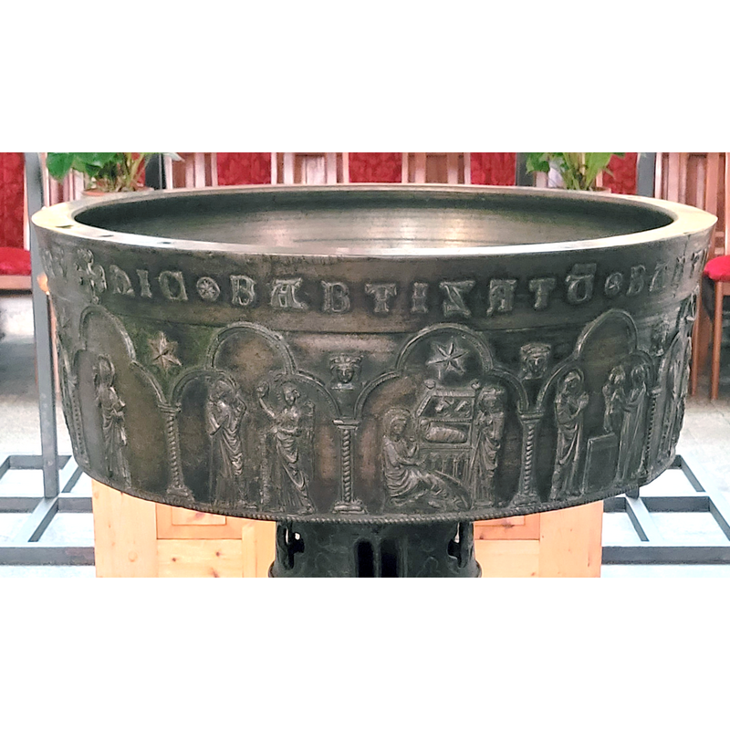 Mary seated on the left; Joseph standing on the right