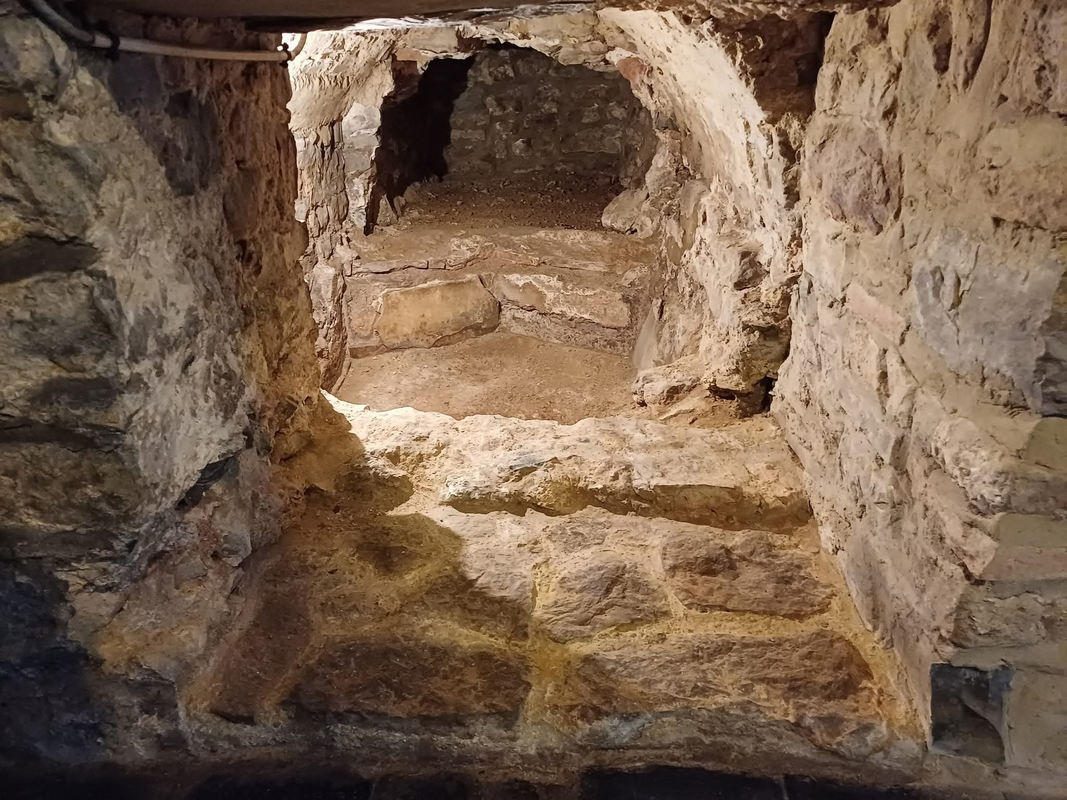 showing the Gallo-Roman piscina in the crypt of the church