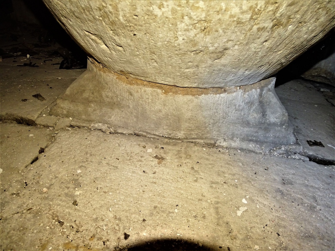 much eroded now but it appears to have some sort of motif in the angles