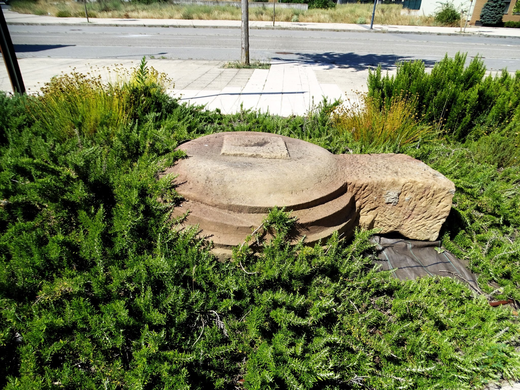 appears to be the base of the old font; now relegated to the outside of the new church