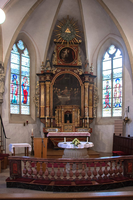 showing the font, covered with a white cloth, when it was used as makeshift altar