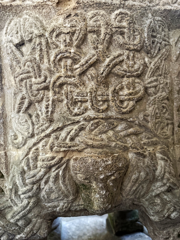 large interlace pattern above; animal head below