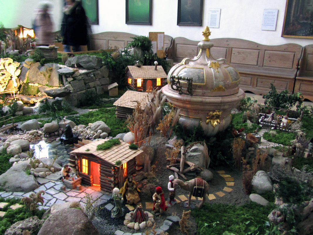 the baptismal font of 1781 surrounded by the Christmas decorations in January of 2025