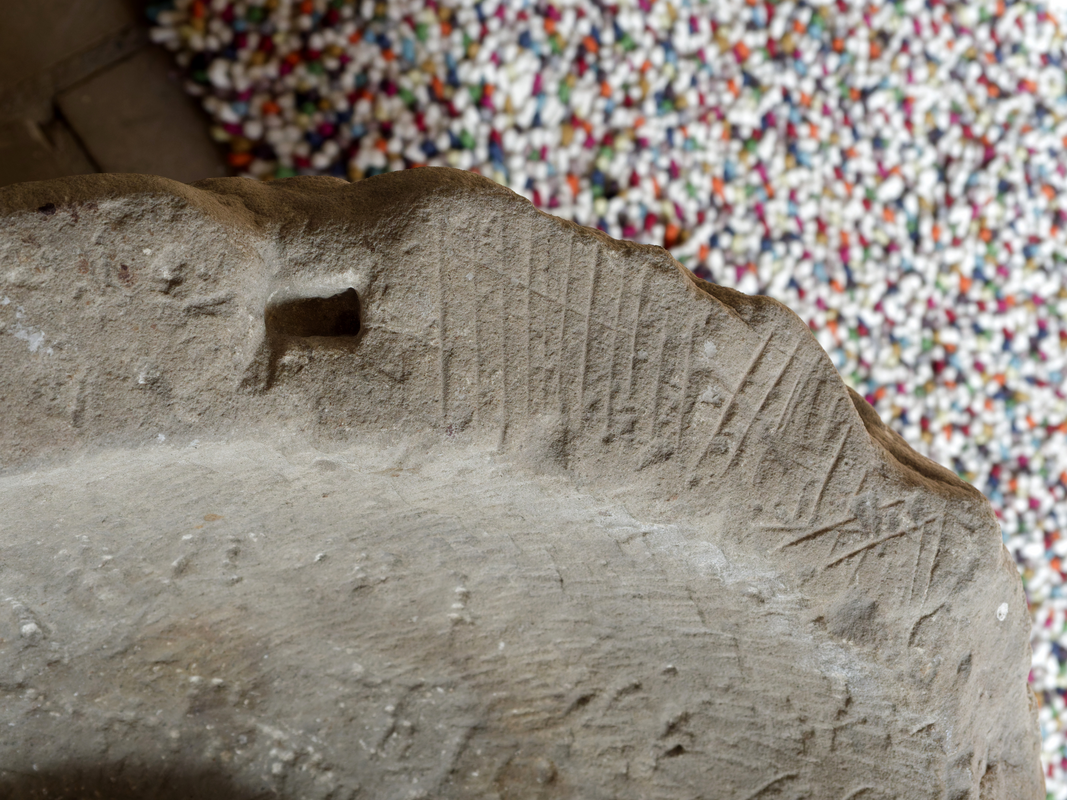 showing the hole from a former anchoring of the font cover