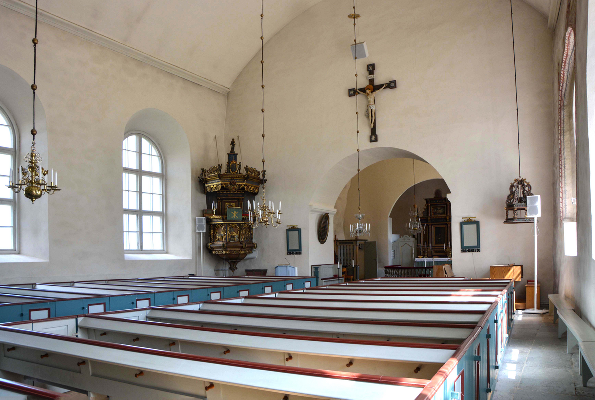 "Ramdala kyrka. Interiör mot öster / Ramdala Church.  The interior of the church looking east." -- notice the position of the font, on the left, by the pulpit, and the font cover, hanging on the right, in the opposite corner of the nave