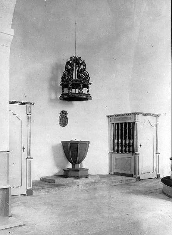 "Interiör mot det nyrestaurerade koret från sydväst med skranken framför predikstols- och torntrapporna samt dopfunten med dess baldakin"