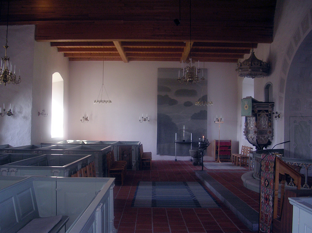 "Östra Sönnarslövs kyrka, interiör" -- showing the stone font in the northeast corner