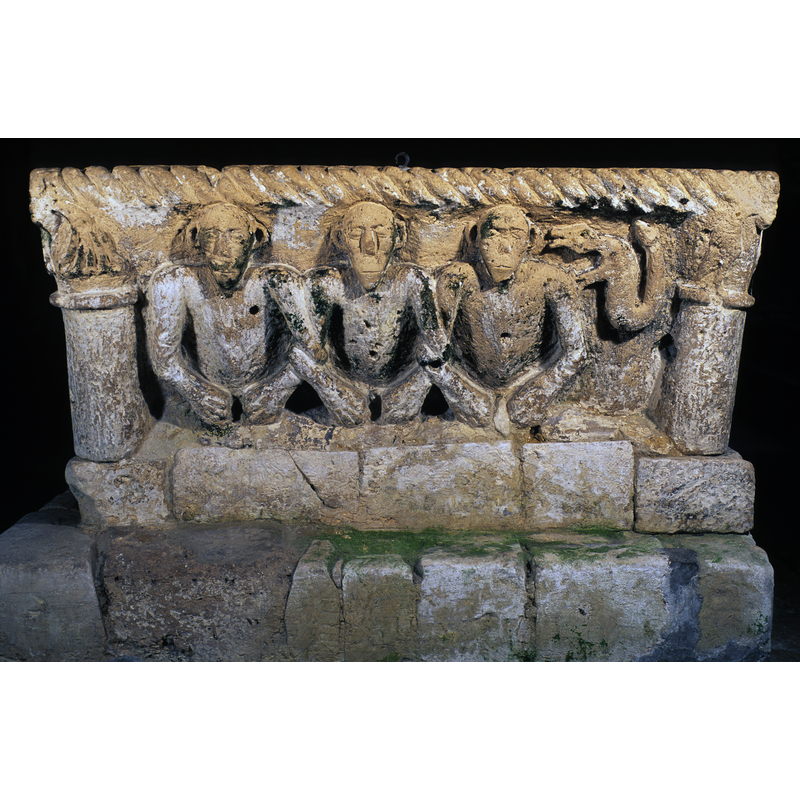 side 1: leaning on the demi-figure to the right; appears to talk to his ear