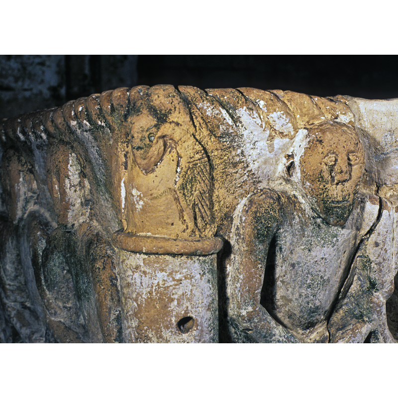 In some capitals at the upper corners of the basin -- this one on side 4, left corner