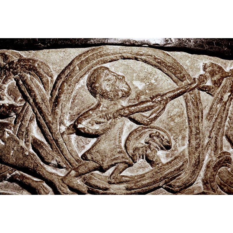 Upper edge of bowl has an ornamental band with three scenes -- the first scene has been claimed as a representation of St. Michael slaying the dragon, but, like the others, it could represent a mythical hunting scene; this is the most human-looking figure on the bowl side but the victim is a fabulous animal, perhaps a dragon