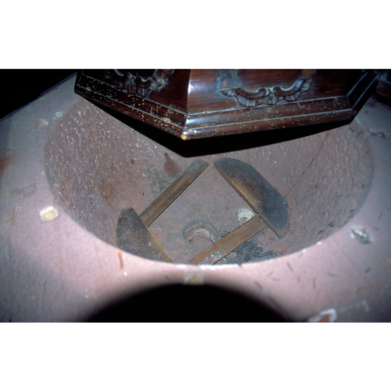 showing the central drain and the wooden frame that holds up the metall inner well insert in use now to hold the holy water for baptisms