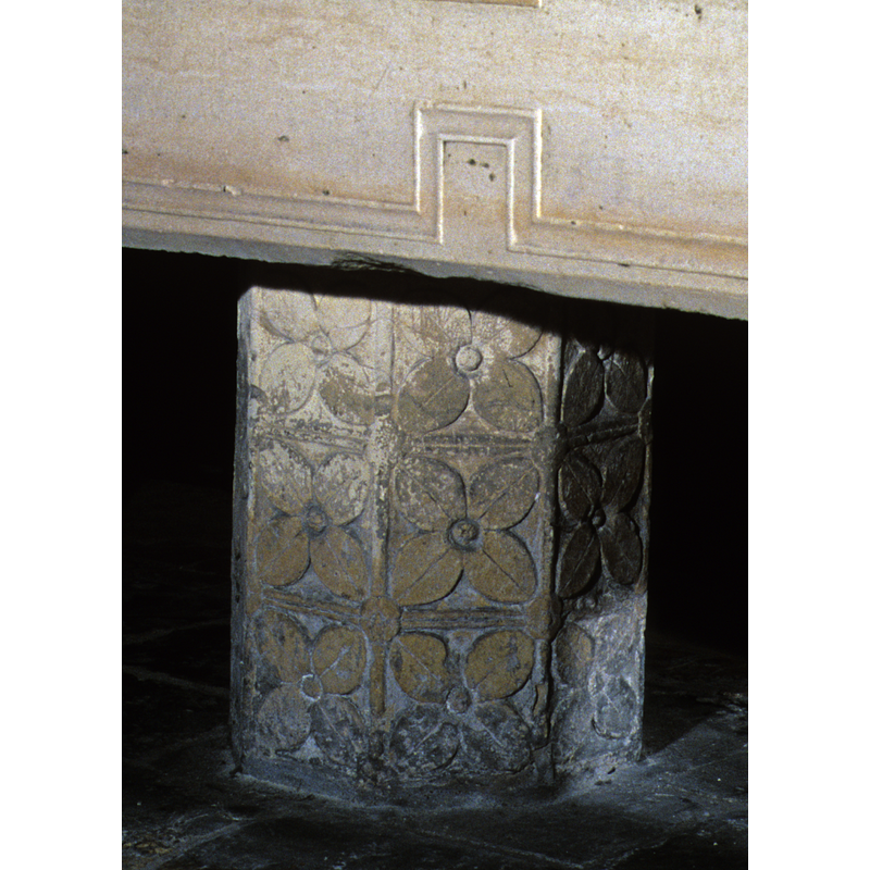 Covering the sides of the 5 columns which make up the base
