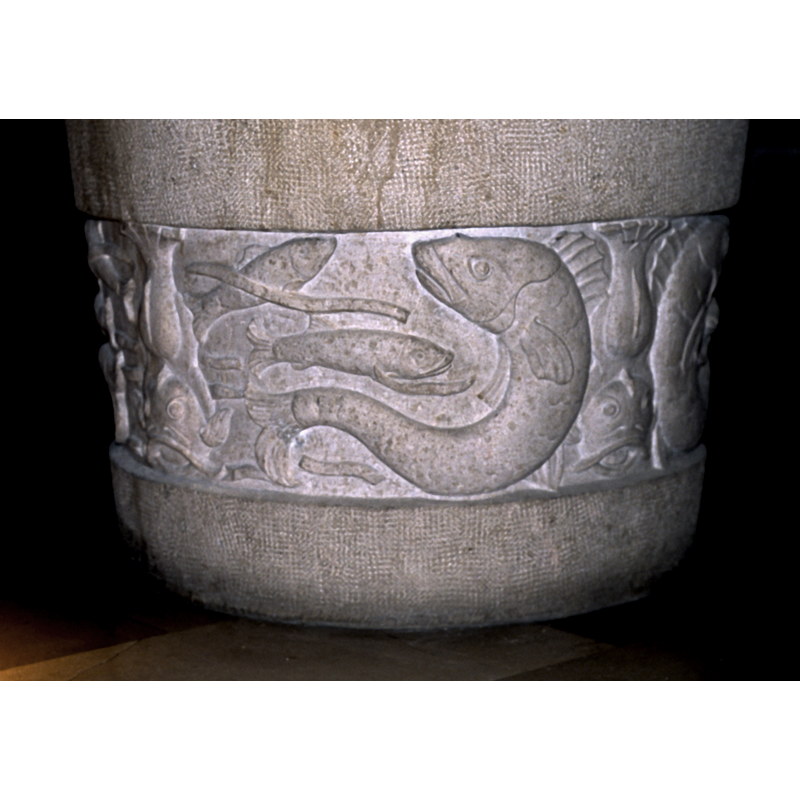 carved on the lower sides of the 20thC font in use