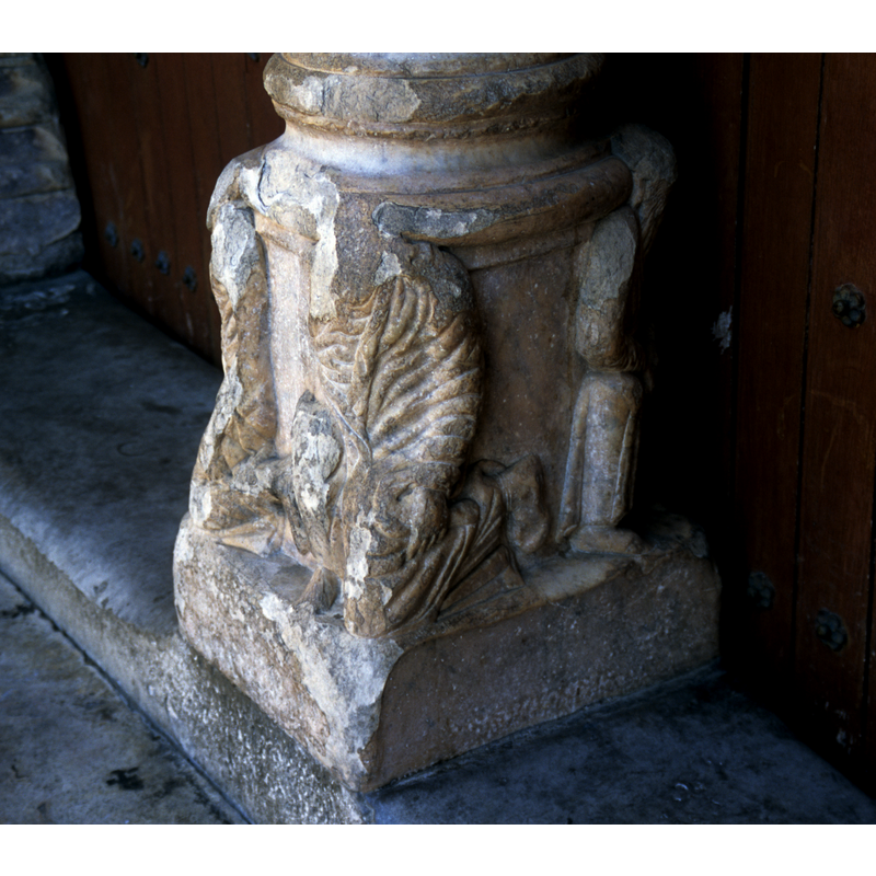 the base od the door mullion, west portal, with figures on their knees; the one at the front, facing west has been badly disfigured