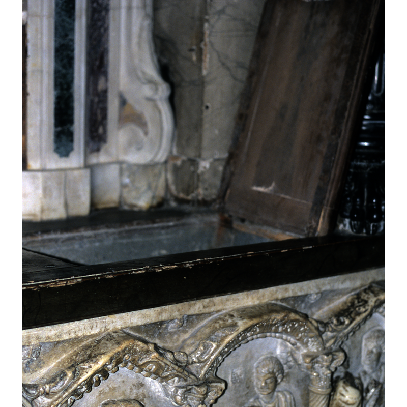 there is a lid at the top of the sarcophagus/altar/font; it opens to provide access to the basin well