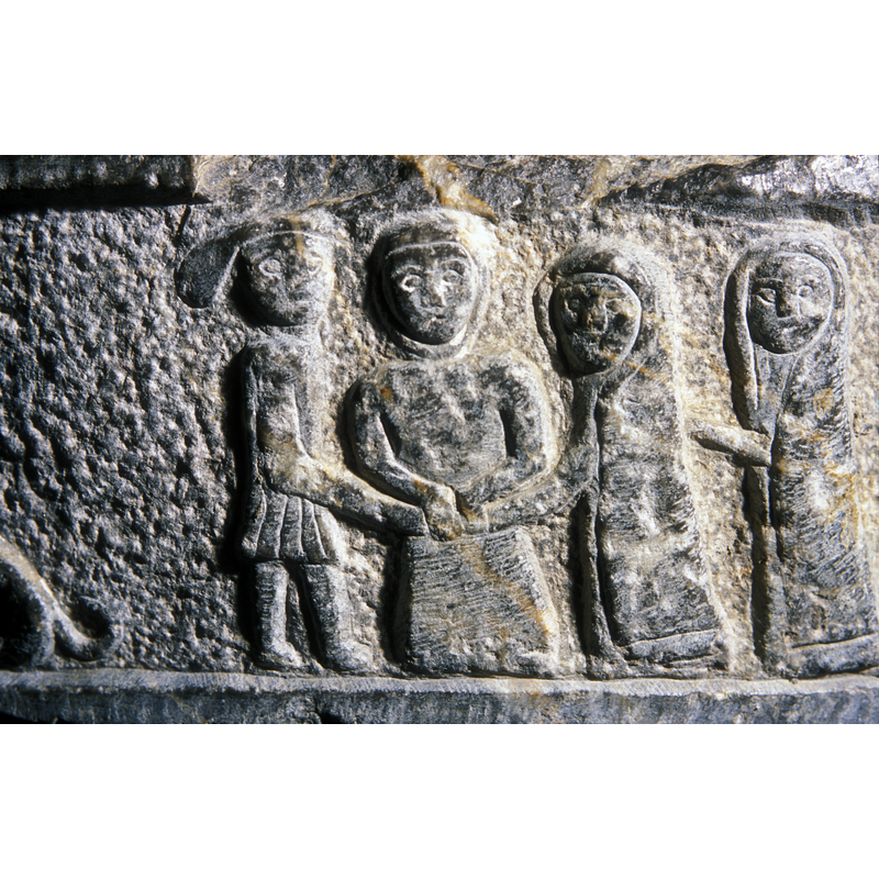 the centre figure holds the hands of the male and the female; to the left, two more female figures in long robes and head-dresses