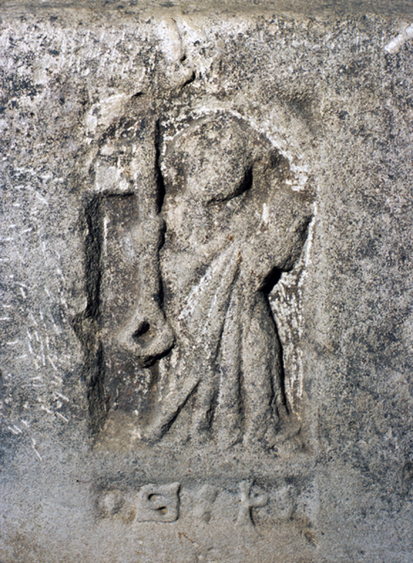 the figure holds a very large key in his right hand