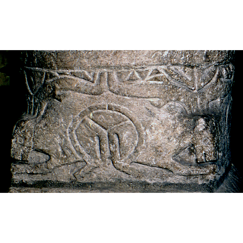 at first sight they look like upward antler-like extensions on the animal heads below, but they are probably a second set of crouching or couchant animals, very schematically rendered
