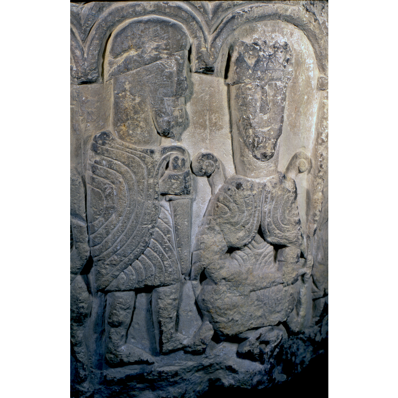 a seated crowned figure has an armed soldier to his left (Herod?)