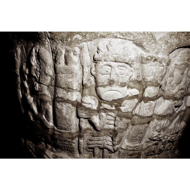the figure, seen here at the extreme left, is looking leftwards holding a cross on a staff (?); the cross resembles a Maltese cross