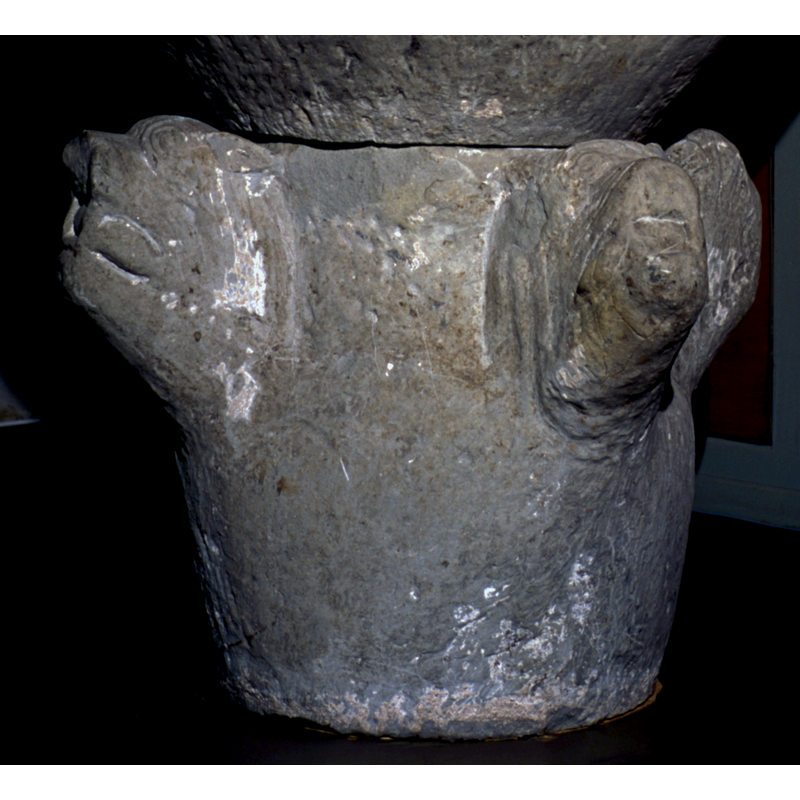 though this base was much re-cut to serve as the basis of a dial, the four characteristic animal heads can still be discerned; there probably were carvings or paintings in the areas between the heads originally