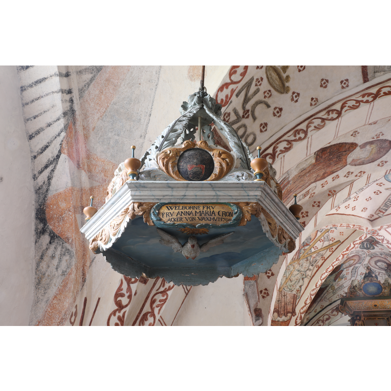although it hangs above the font, it is probably not a cover for the font, but probably the sounding board of an earlier pulpit