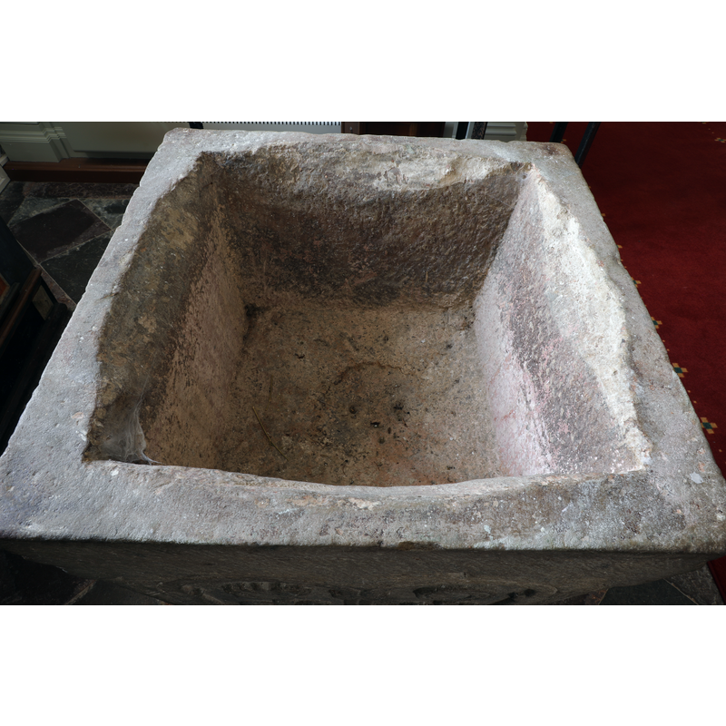 at some point the square inner basin shape was hacked to accommodate a round baptismal dish too large to fit in