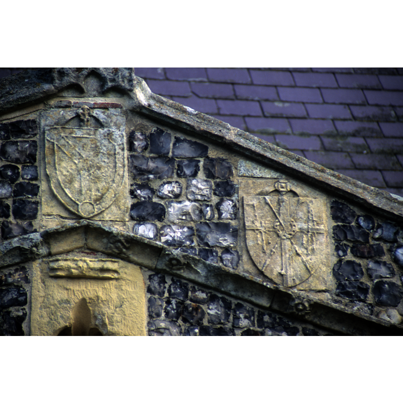 at the centre, the emblem of the Trinity; to the right, the Instruments of the Passion