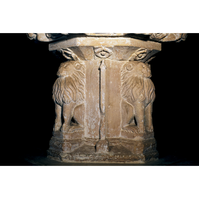 One on each side of the square stem of the base
