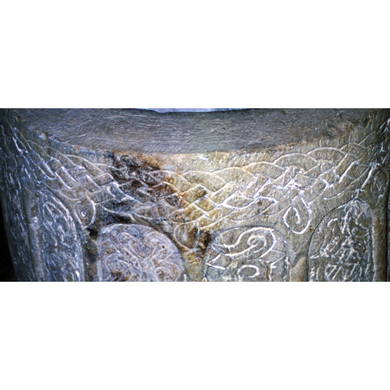 all around the upper side of the basin, below the upper rim; it has hanging loops at regular intervals that coincide with the spandrels of the arcade