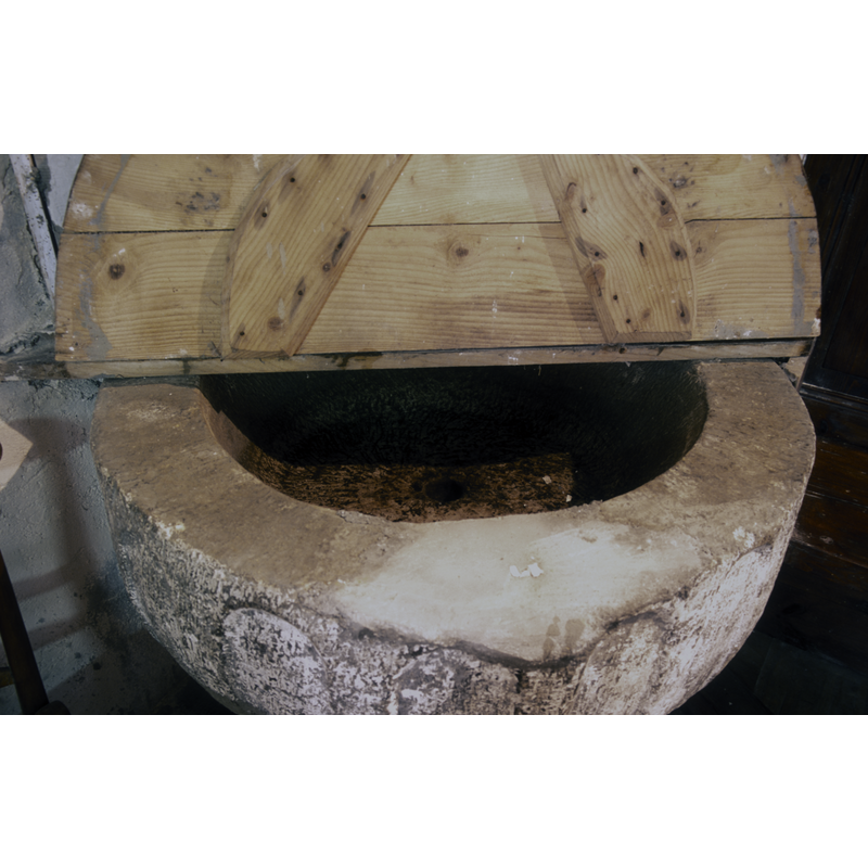 showing part of the basin interior and the centre drain hole -- the repair to the front of the upper rim may have been done for damage related to the hardware of an old font cover