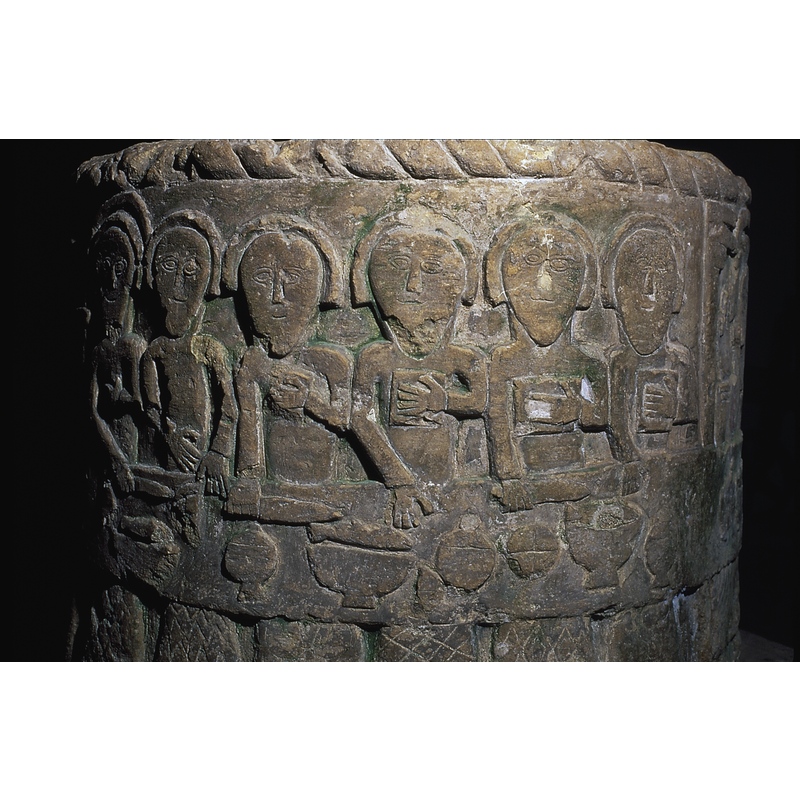 Last Supper. 12 apostles are present with Christ seated in the centre -- only six of the Apostles visible in this image, the six seated on the right side of Christ [NB: the scene takes practically half of the surface of the font and is therefore impossible to photograph whole]