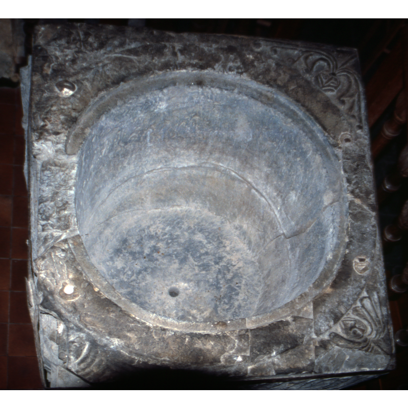 remains of metal anchors from an old font cover are still visible here; notice also the lead lined inner basin and the centre drain hole