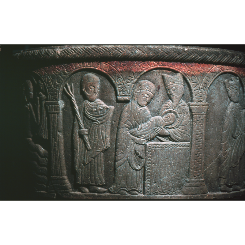 Presentation in the Temple. Under the first arch to the right, Mary, haloed, head covered, holds the child and extends it to Simeon over the altar. Under the second arch stands, a figure, frontal, Joseph, the left arm holds three doves in a cloth and the right hand holds a trident like staff, twisted rod. Simeon stands behind the altar.