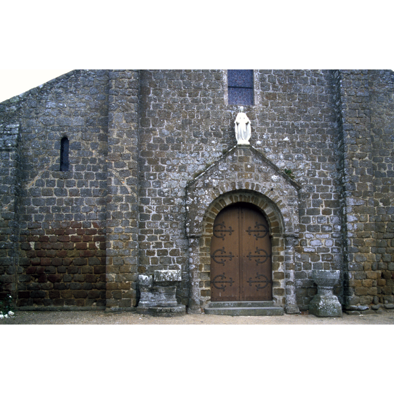 outside the church, on the south side of the west portal