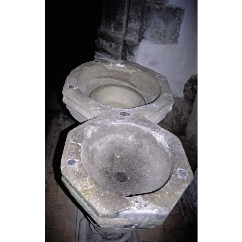 showing the drainage in one of the basins; also visible are the lead plugs and the damage related to an old font cover hardware in the upper rims of both basins