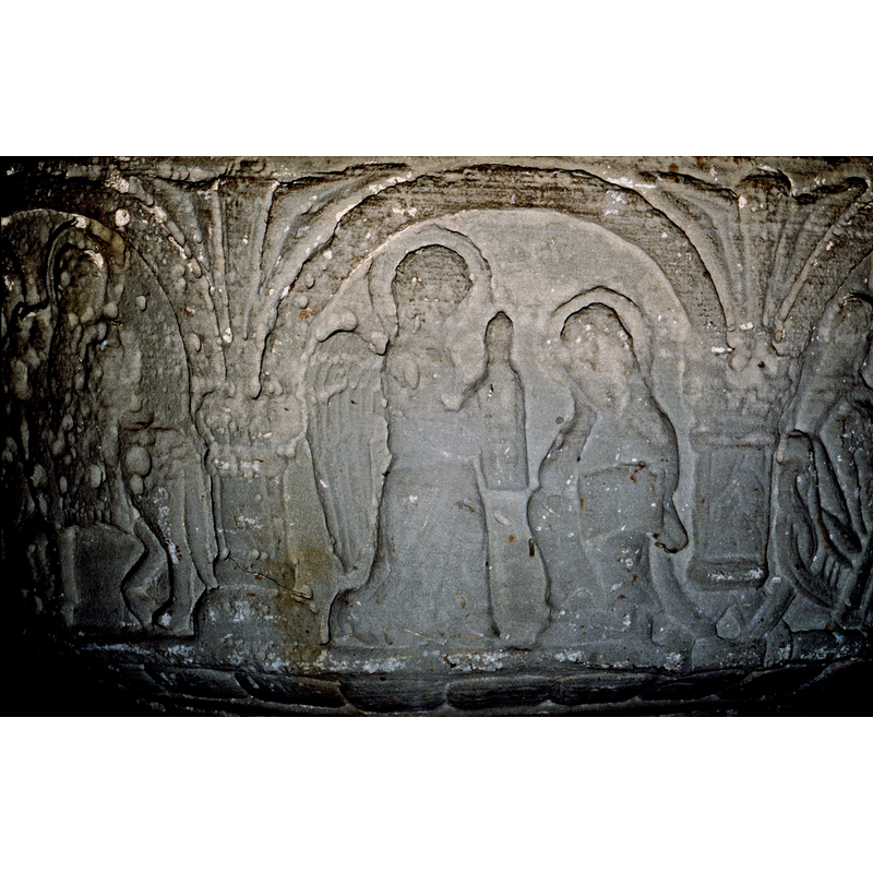 To the right is Joseph, seated, haloed and head rests on the right hand, the left hand holds a book open to the viewer - to the left in profile, an angel, haloed and holds up something in a cloth draped over its hand. This may also be the warming to Joseph?