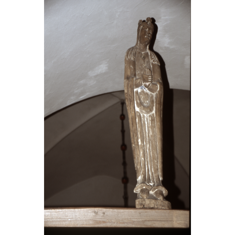 Mary holds her left palm in a sign of grief -- the two figures, Mary and John are carved in linden wood and dated ca.1200; the present Crucifix is a later work