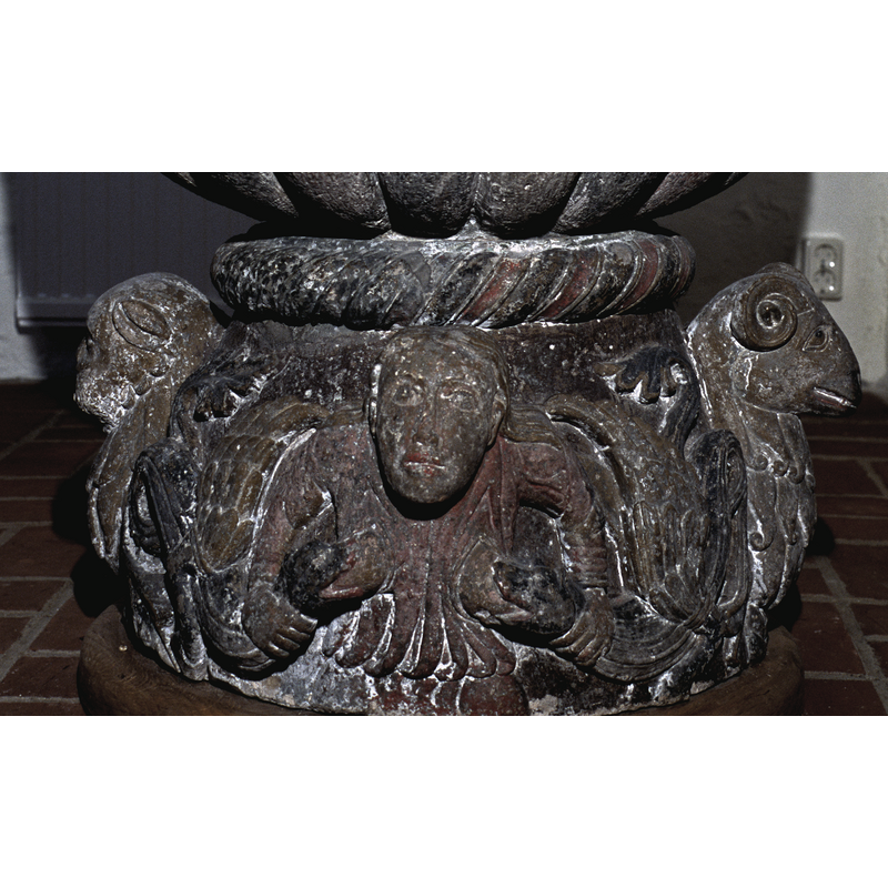 She holds the two winged beasts by the sruff of the neck