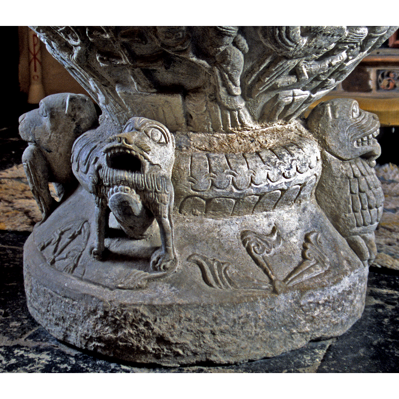 the secondd of the two large protruding animal heads with prey in their jaws